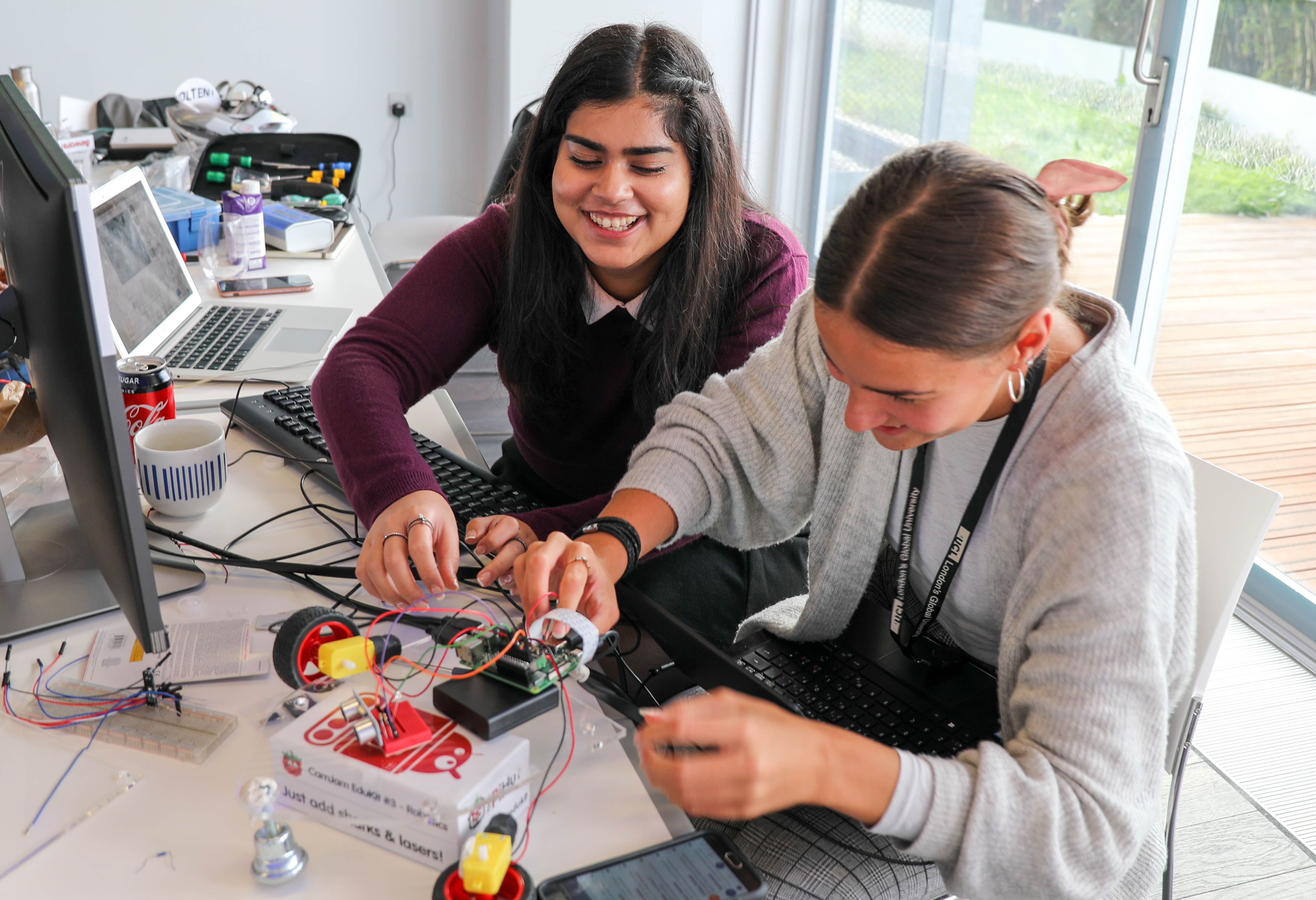 Photo of two SWC students building a robot during boot camp
