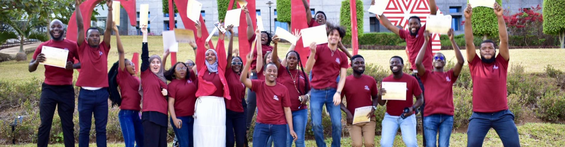 CaMinA students jump for joy with their certificates in hand