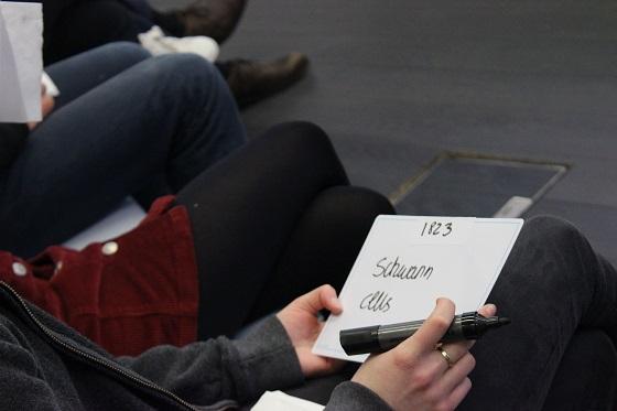 A contestant writes down answers to be displayed on the whiteboard during Brain Bee A contestant writes down answers to be displayed on the whiteboard during Brain Bee